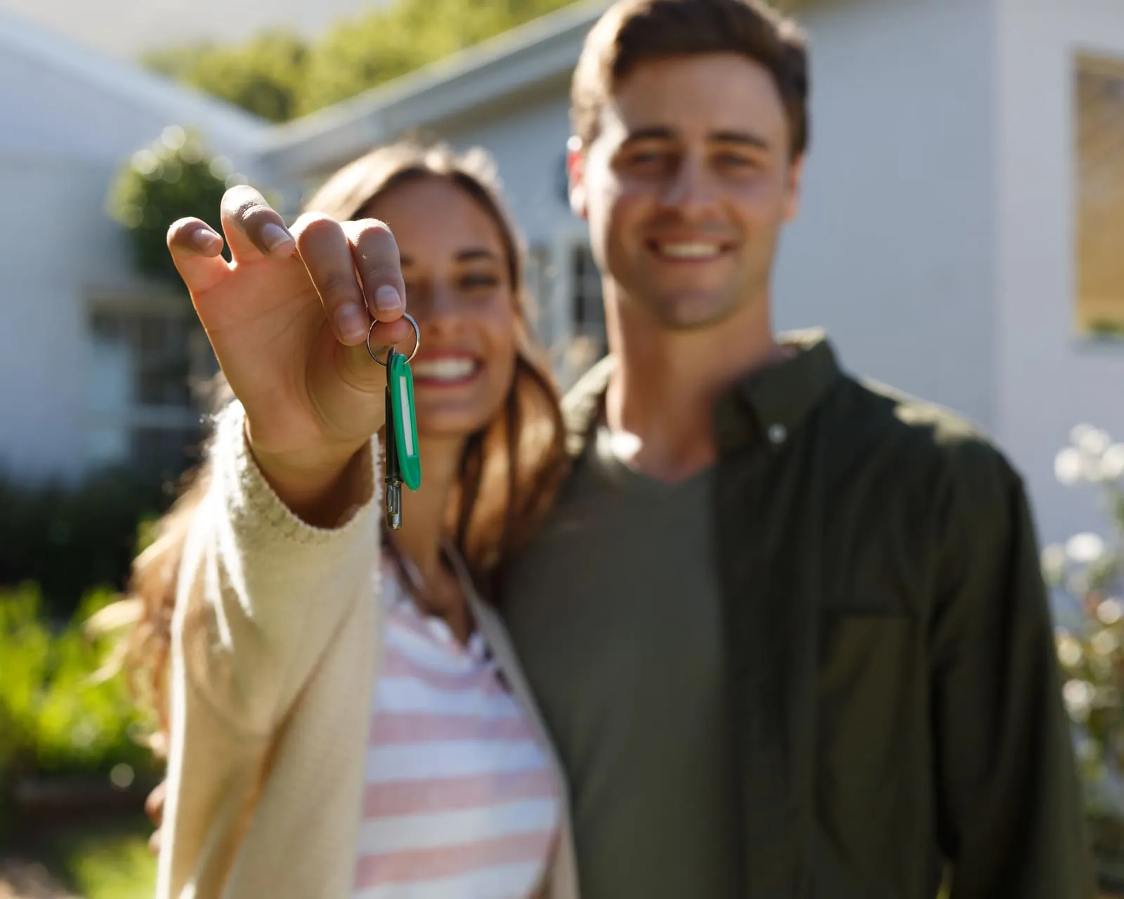 A couple holding up the keys to their new home